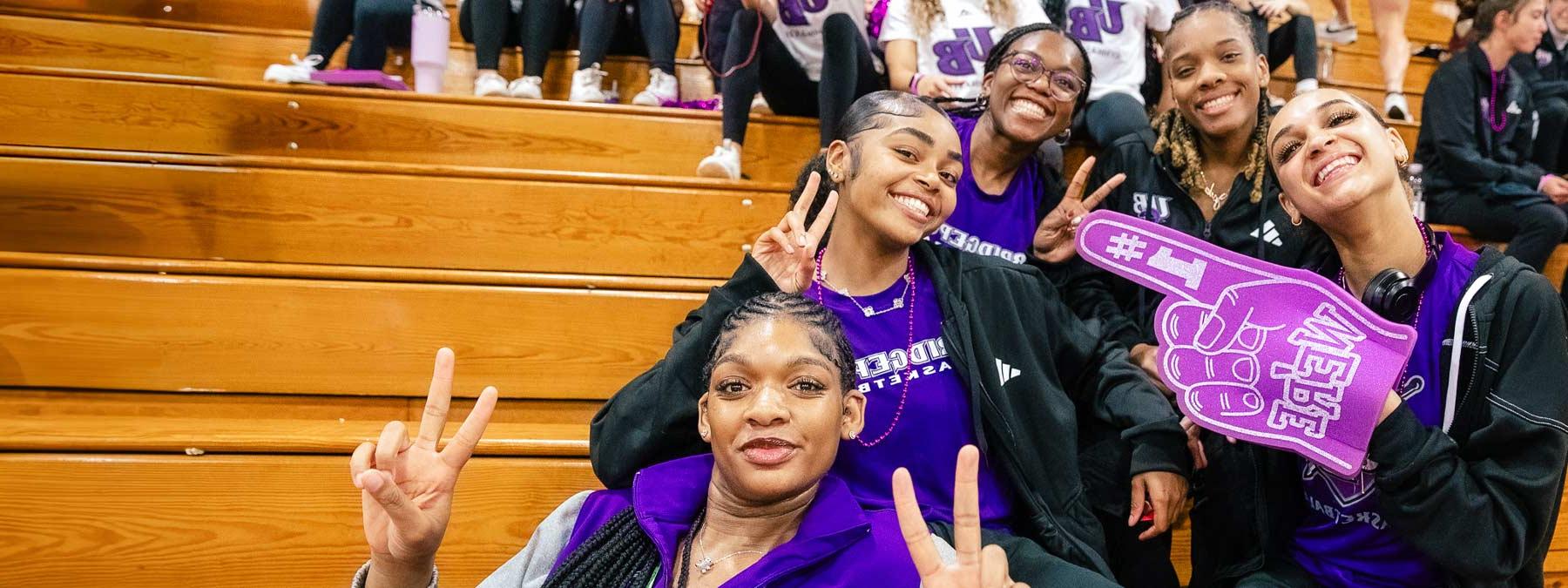 students giving peace sign at pep rally